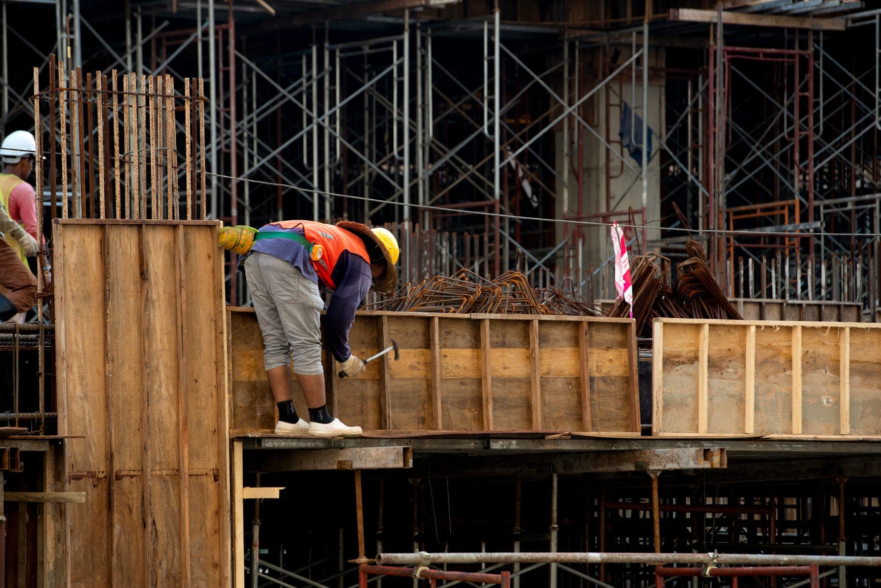 Carpenter setting timber formwork on a construction site